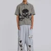 Abgenutzte graue melierte, weite Monster Joggers