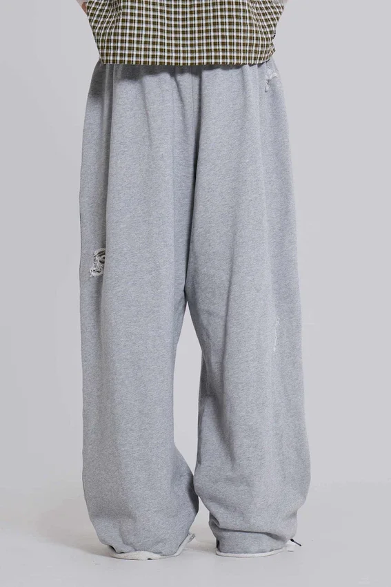 Abgenutzte graue melierte, weite Monster Joggers