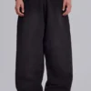 Schwarze, weite „Monster Joggers“ mit Umschlag